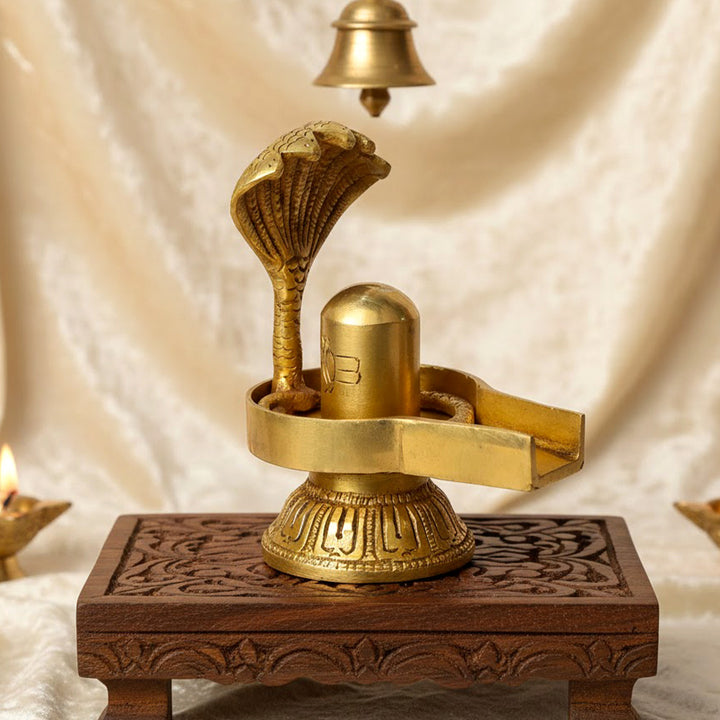 4.7 Inch Handcrafted Brass Shivling with Sheshnaag coiled gracefully around the sacred symbol of Lord Shiva, representing protection, eternity, and divine energy. No.1 Brass Idol Store www.satvikstore.in 