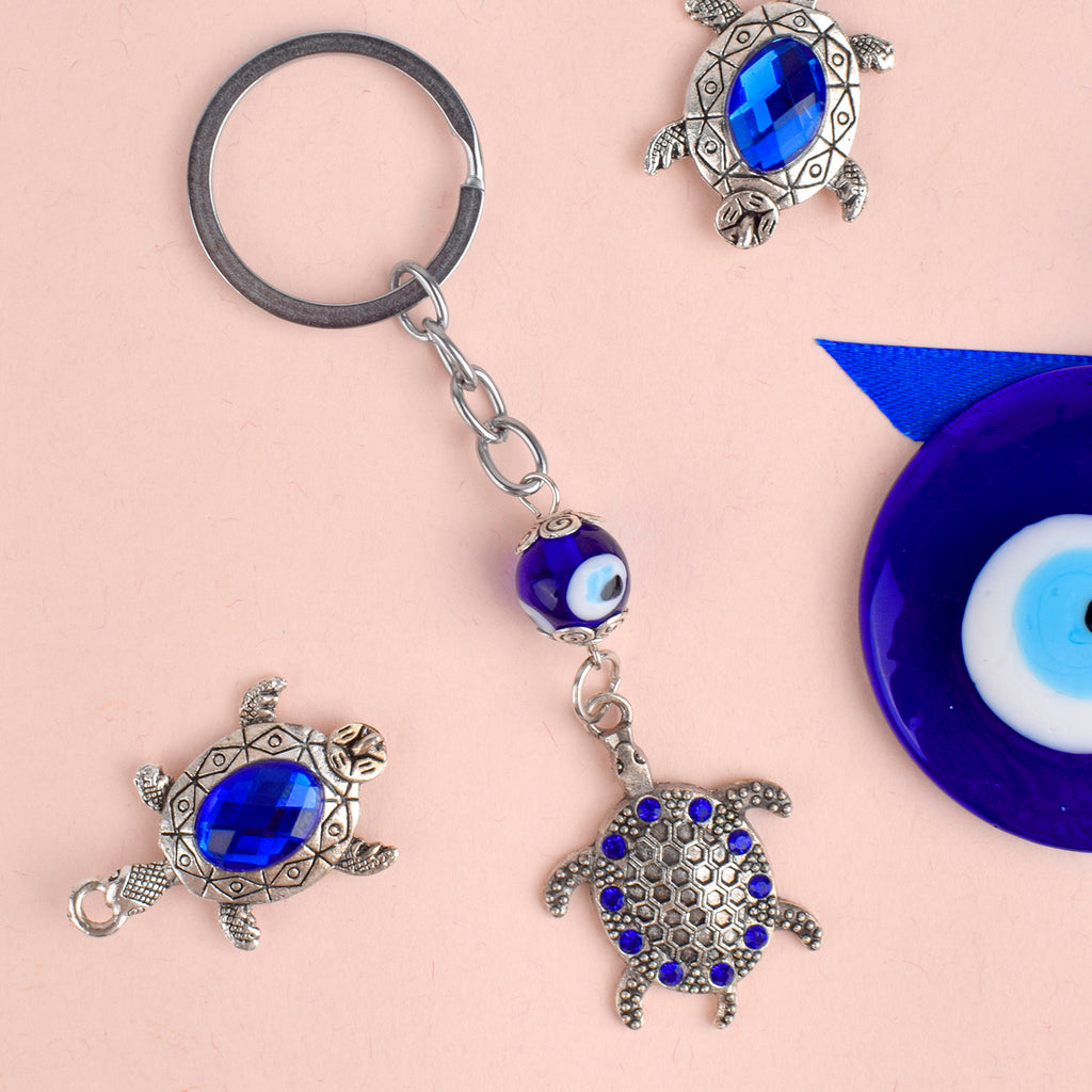 Blue Bead Silver Plated Evil Eye Turtle Keychain – A stylish and protective keychain with blue beads and an evil eye charm, perfect for your bike or car. India’s Largest Pooja Accessories Brand – www.satvikstore.in