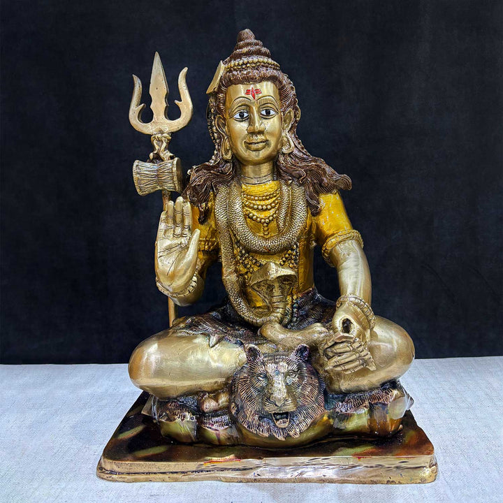  Brass Idol of 17.5 Inch Brass Lord Shiva Statue in Meditation Pose. Embodying peace and spiritual focus, this 17.5-inch Brass Shiva Idol features Lord Shiva in a serene meditative posture. Known as the ultimate yogi, Lord Shiva is beautifully represented here with intricate detailing in brass, capturing the tranquility and profound wisdom of his meditation on. India's Largest Puja Accessories Brand - Satvik No 1 Brass Idol Collection.