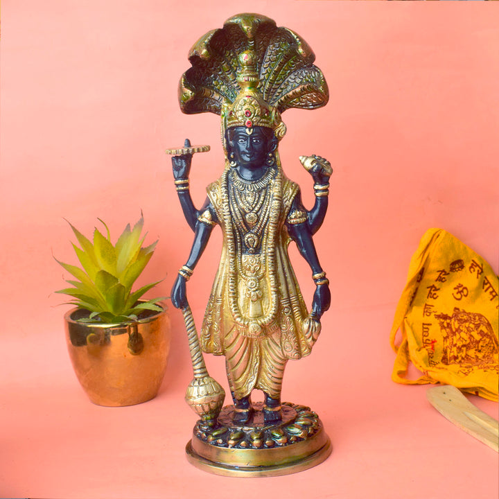  This elegant brass statue of Lord Vishnu seated on the mighty Seshnag is a powerful symbol of divine protection, balance, and cosmic order. The intricate craftsmanship beautifully depicts Lord Vishnu in his serene and majestic form, with the multi-headed Seshnag providing a protective canopy. 