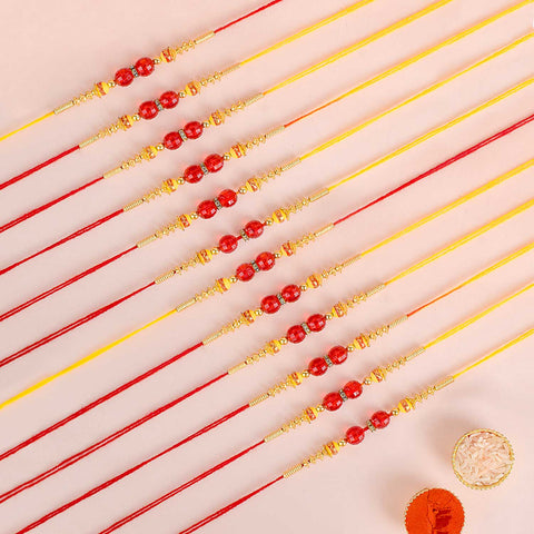 Assortment of 12 Rakhis, featuring different designs, threads, and embellishments for Raksha Bandhan. India’s Largest Pooja Accessories Brand - www.satvikstore.in