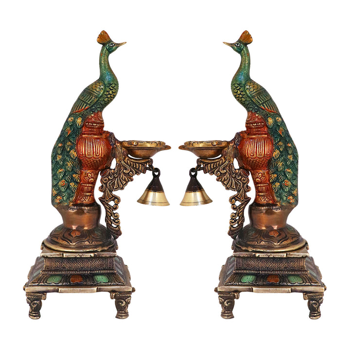 Satvik Stores Presents Brass Peacock Diya Stand.&nbsp;Any festive occasion will be made wonderfully auspicious by the grace and beauty of the Peacock Brass Handcrafted Hanging Diya. Given that it was made by hand, the piece's abnormalities and flaws only serve to enhance Diya's allure and charisma.