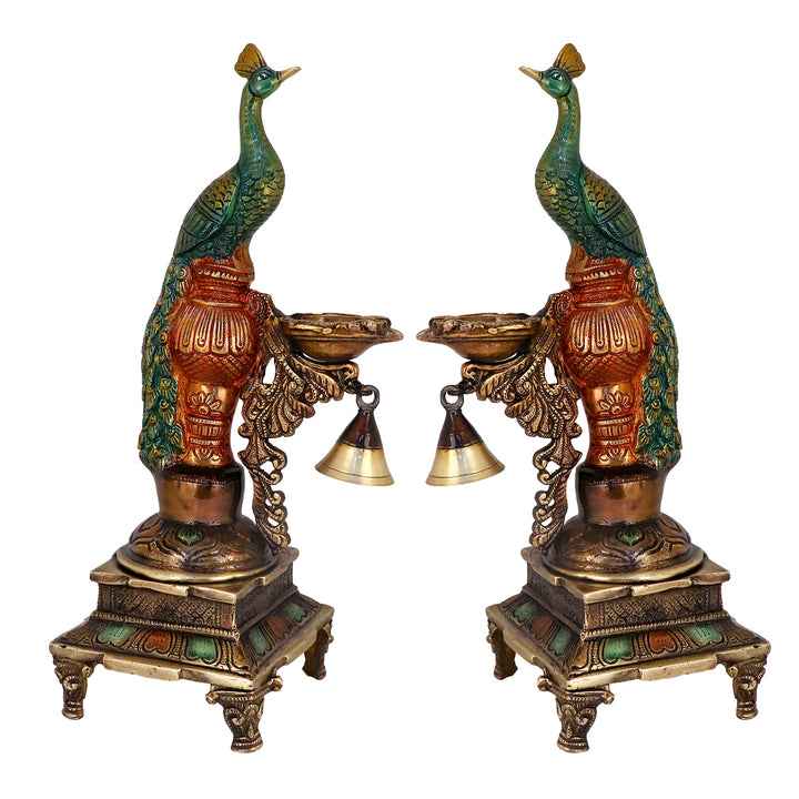 Satvik Stores Presents Brass Peacock Diya Stand.&nbsp;Any festive occasion will be made wonderfully auspicious by the grace and beauty of the Peacock Brass Handcrafted Hanging Diya. Given that it was made by hand, the piece's abnormalities and flaws only serve to enhance Diya's allure and charisma.
