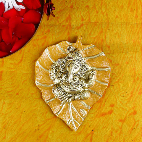 Yellow wall hanging featuring Lord Ganesh intricately crafted on a leaf-shaped patta, ideal for home temple or spiritual décor. India’s Largest Pooja Accessories Brand – www.satvikstore.in